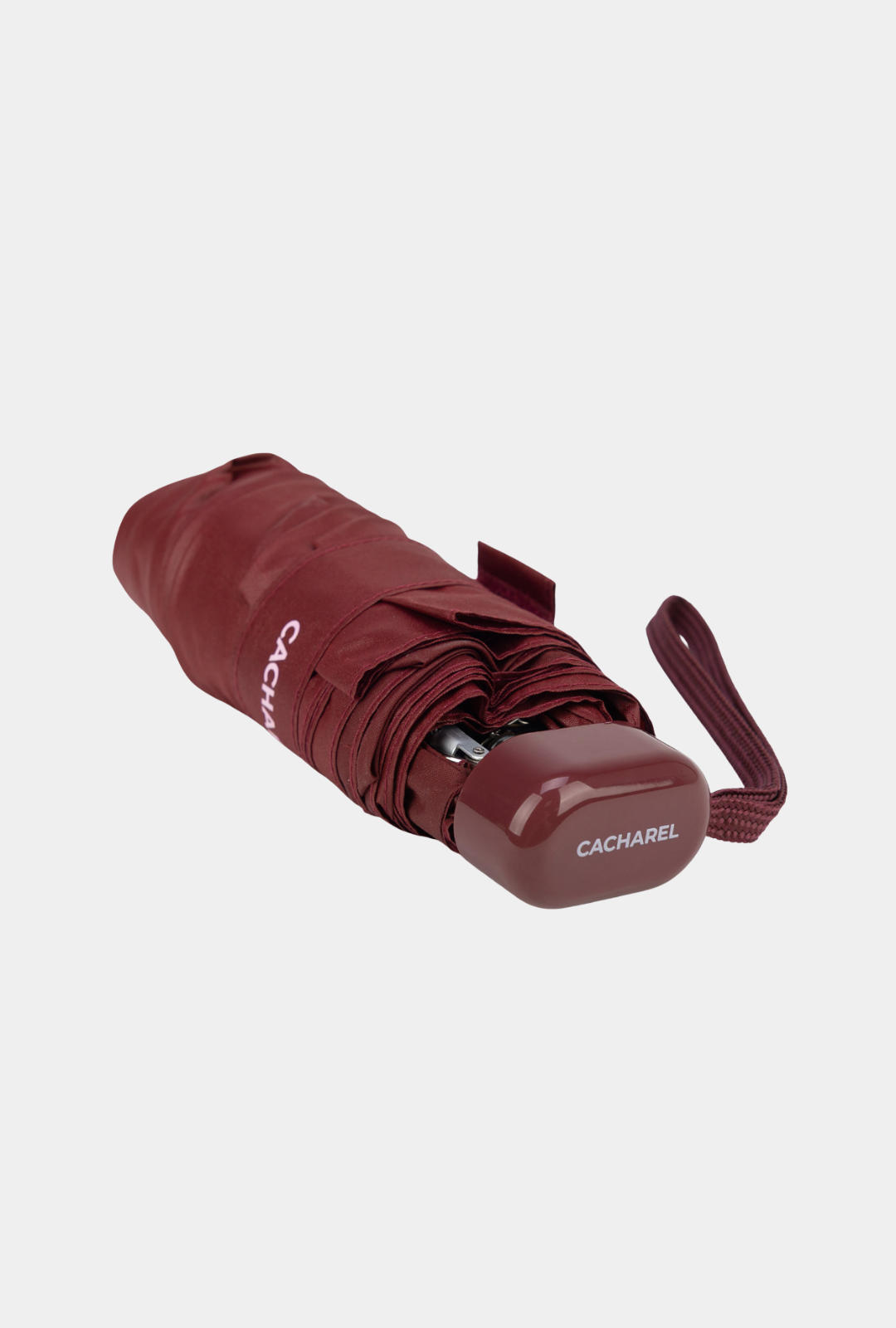 Paraguas plegable Cacharel con protección solar UPF 50+ color burdeos enrollado