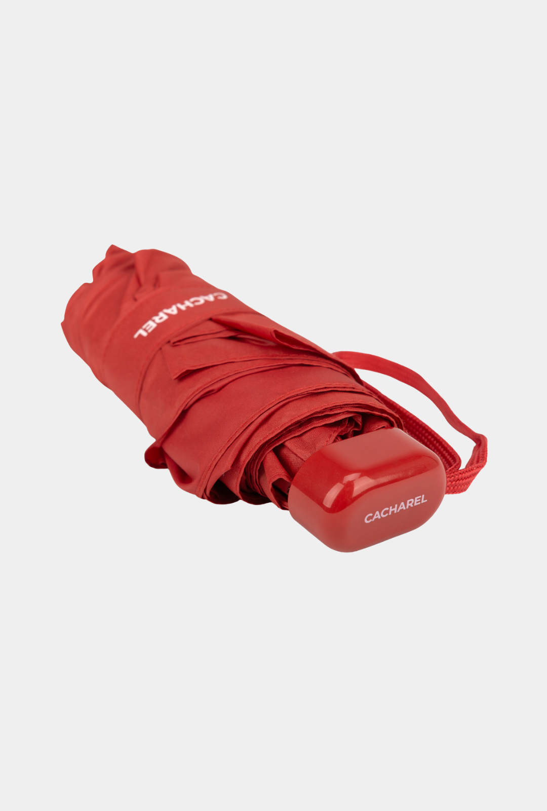 Paraguas plegable Cacharel con protección solar UPF 50+ color rojo amapola enrollado