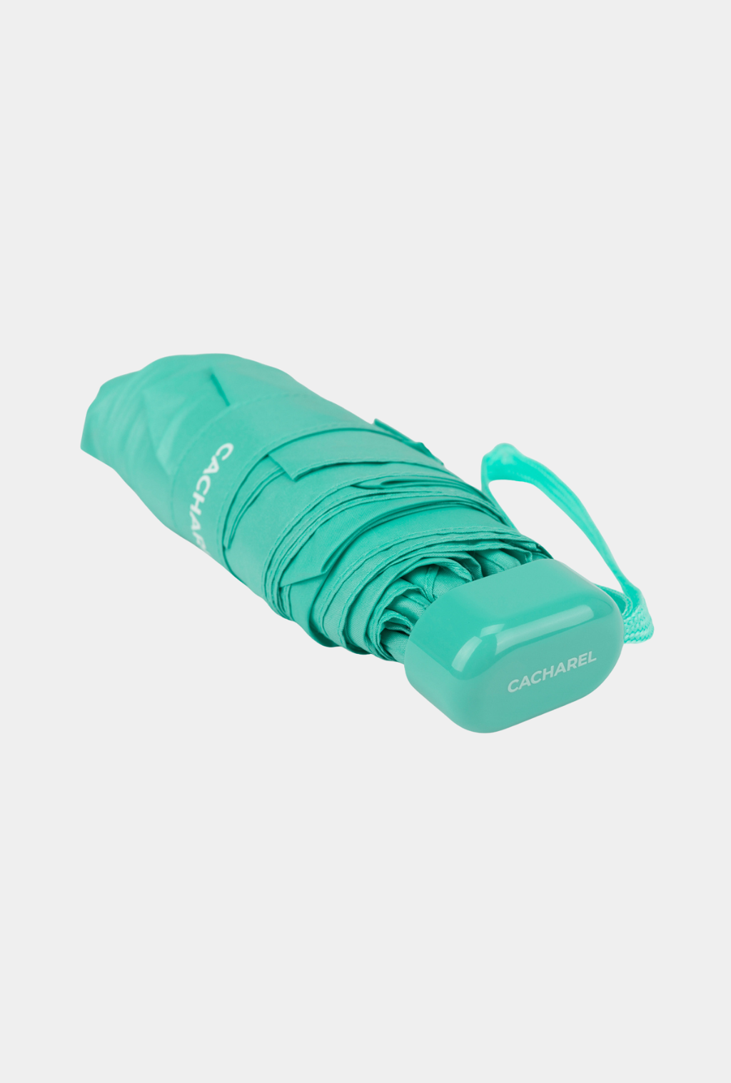 Paraguas plegable Cacharel con protección solar UPF 50+ color verde agua enrollado